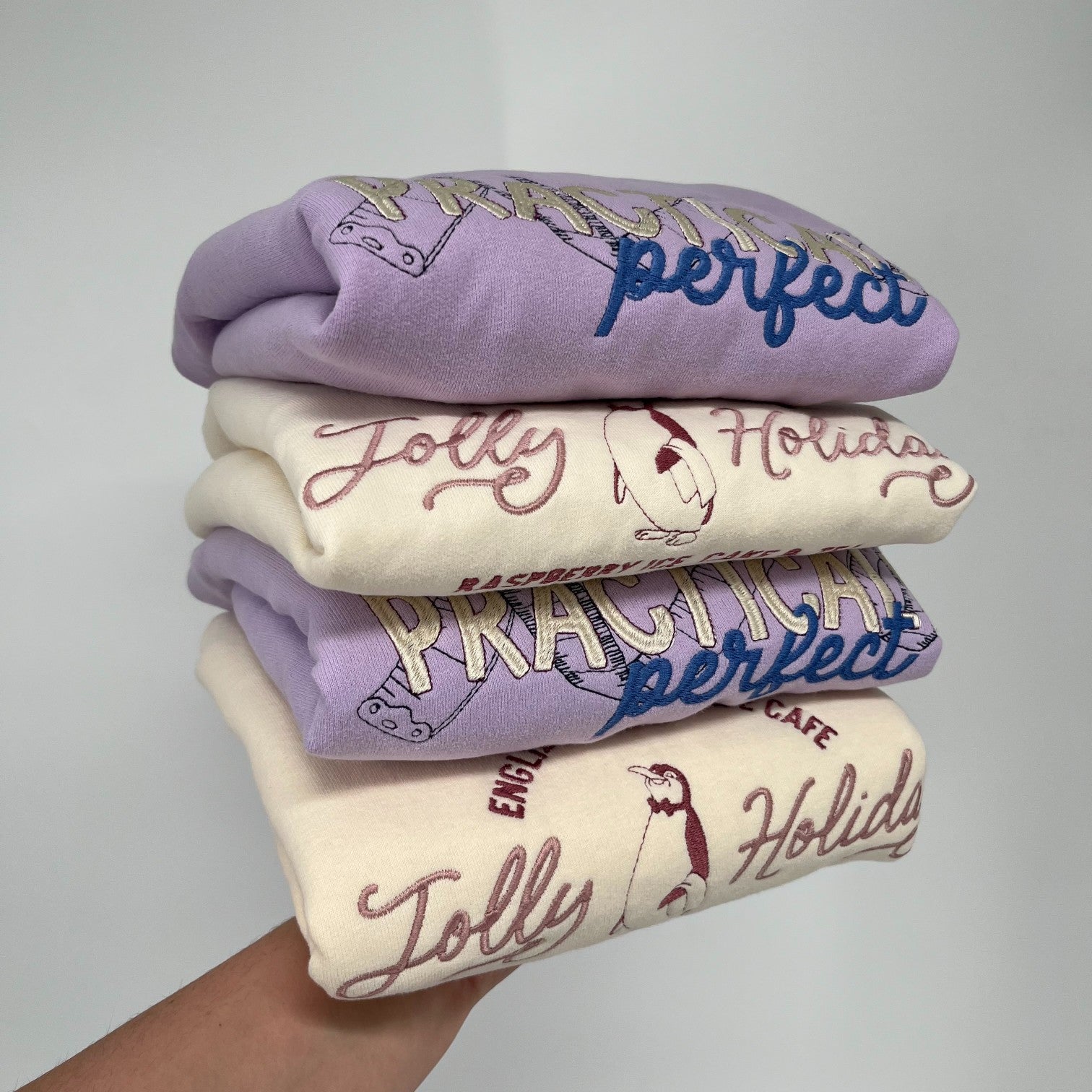 Stack of crewneck sweatshirts from Hundred Acre Threads Embroidered Designs
